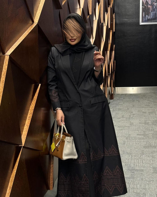 Elegant black abaya with pockets and decorations at the bottom